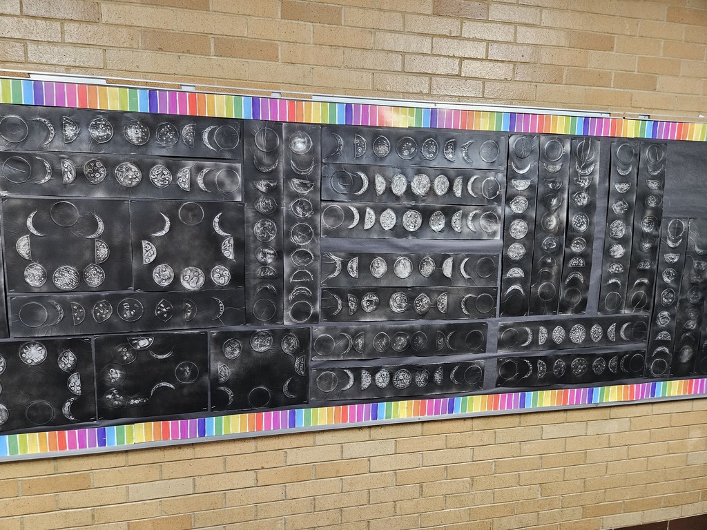 Bulletin board with art work showing moon phases