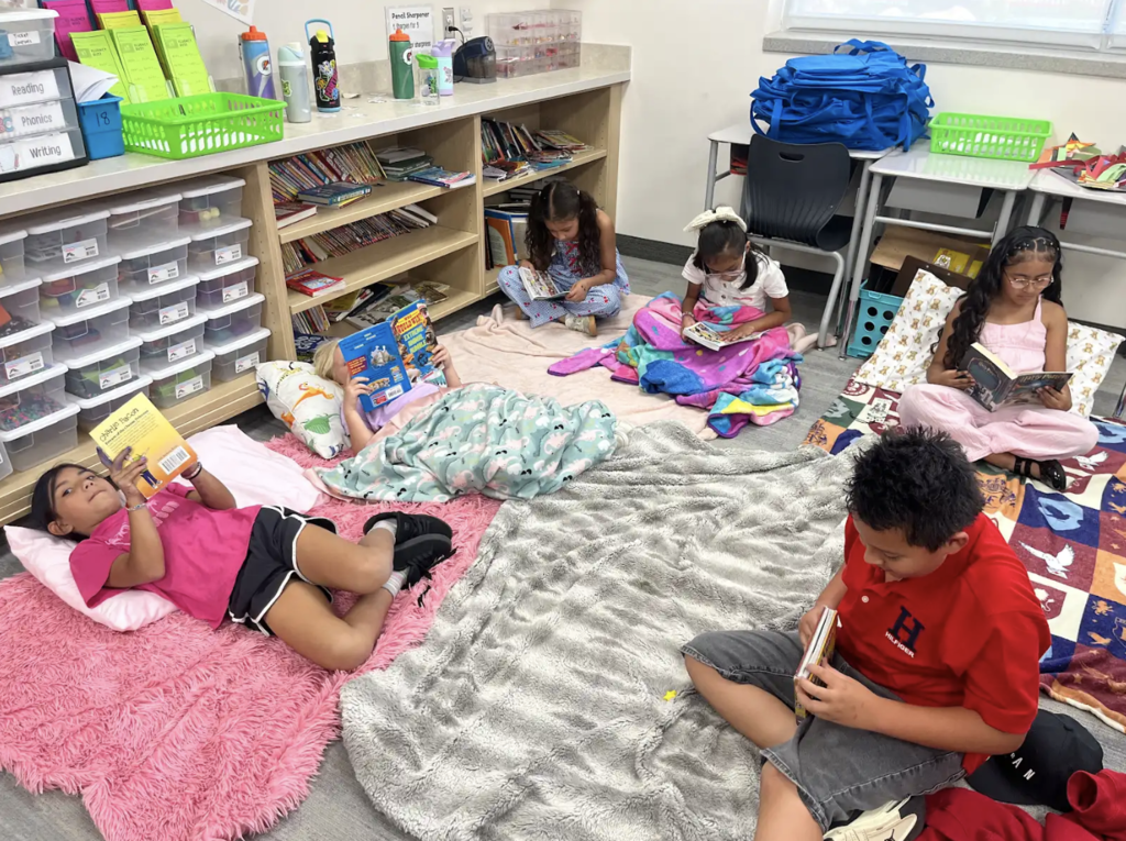 students sitting on the floor reading