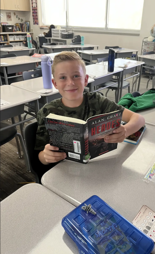 student reading at a desk