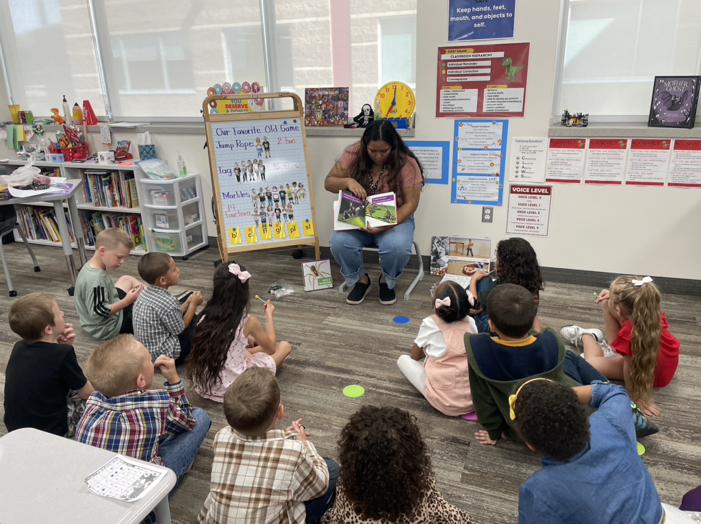 teacher reading to a group of students