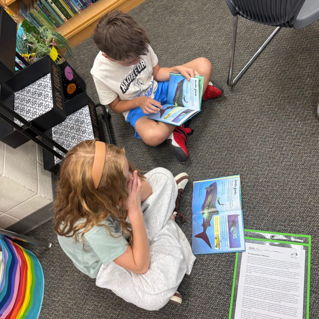 Students reading books with each other.