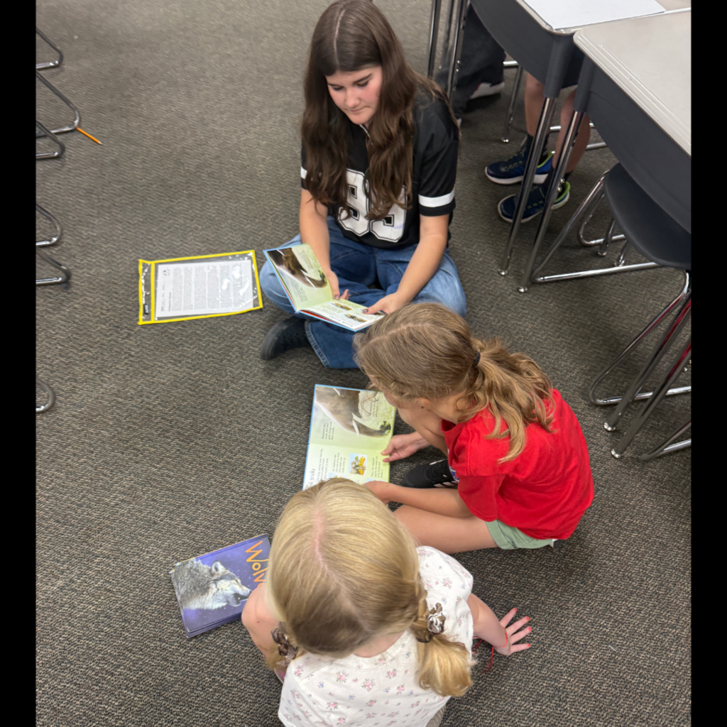 Students reading books with each other.