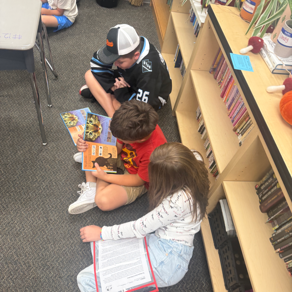 Students reading books with each other.