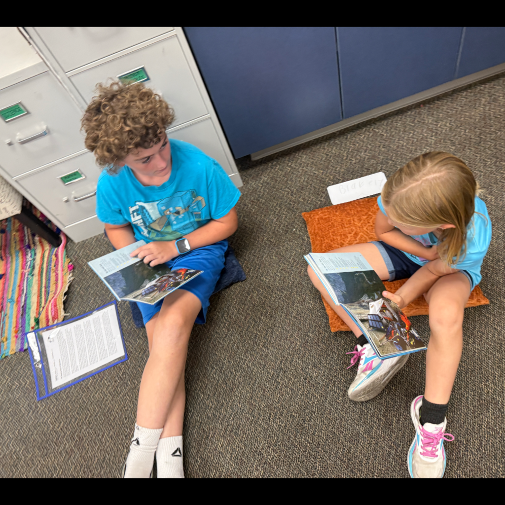 Students reading books with each other.