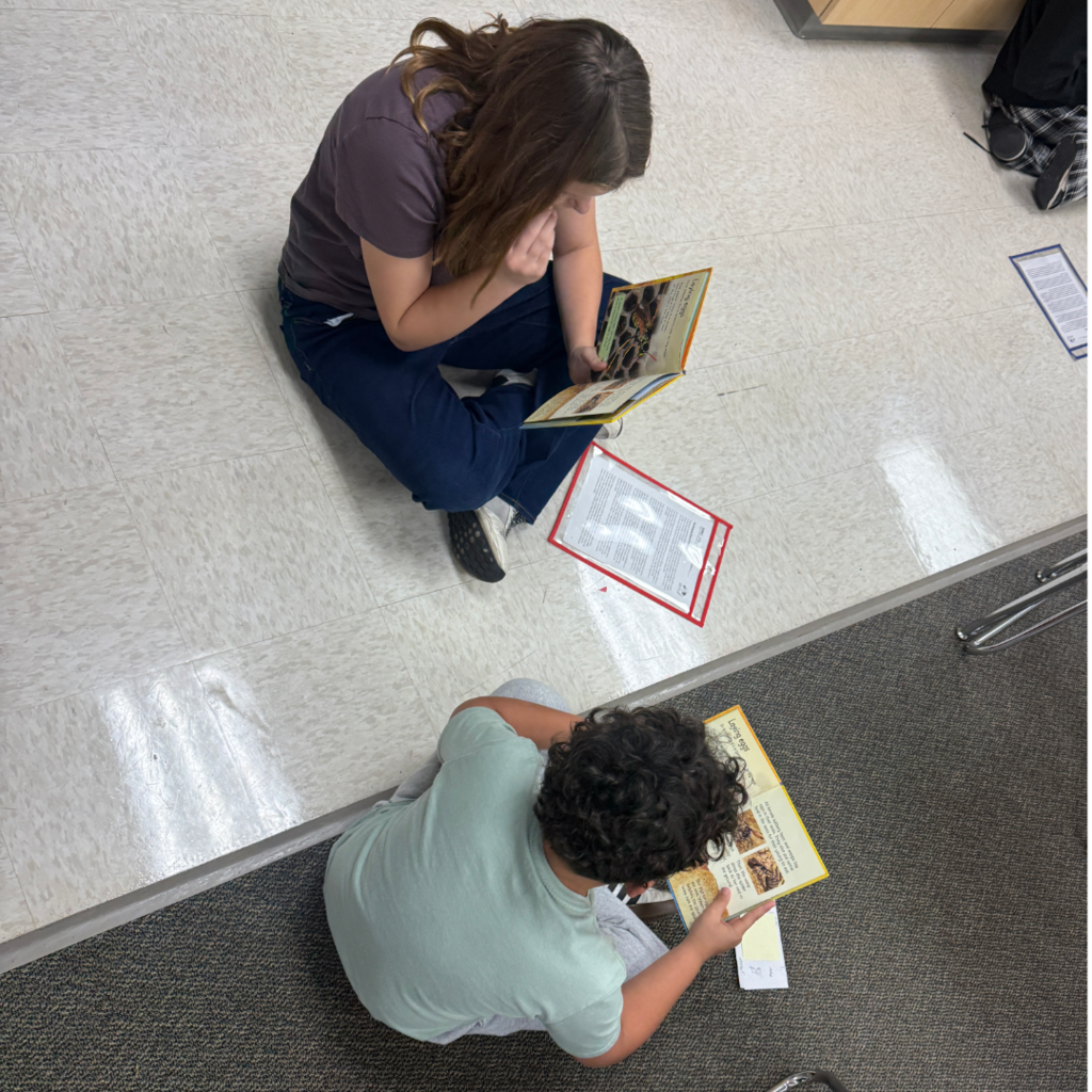Students reading books with each other.