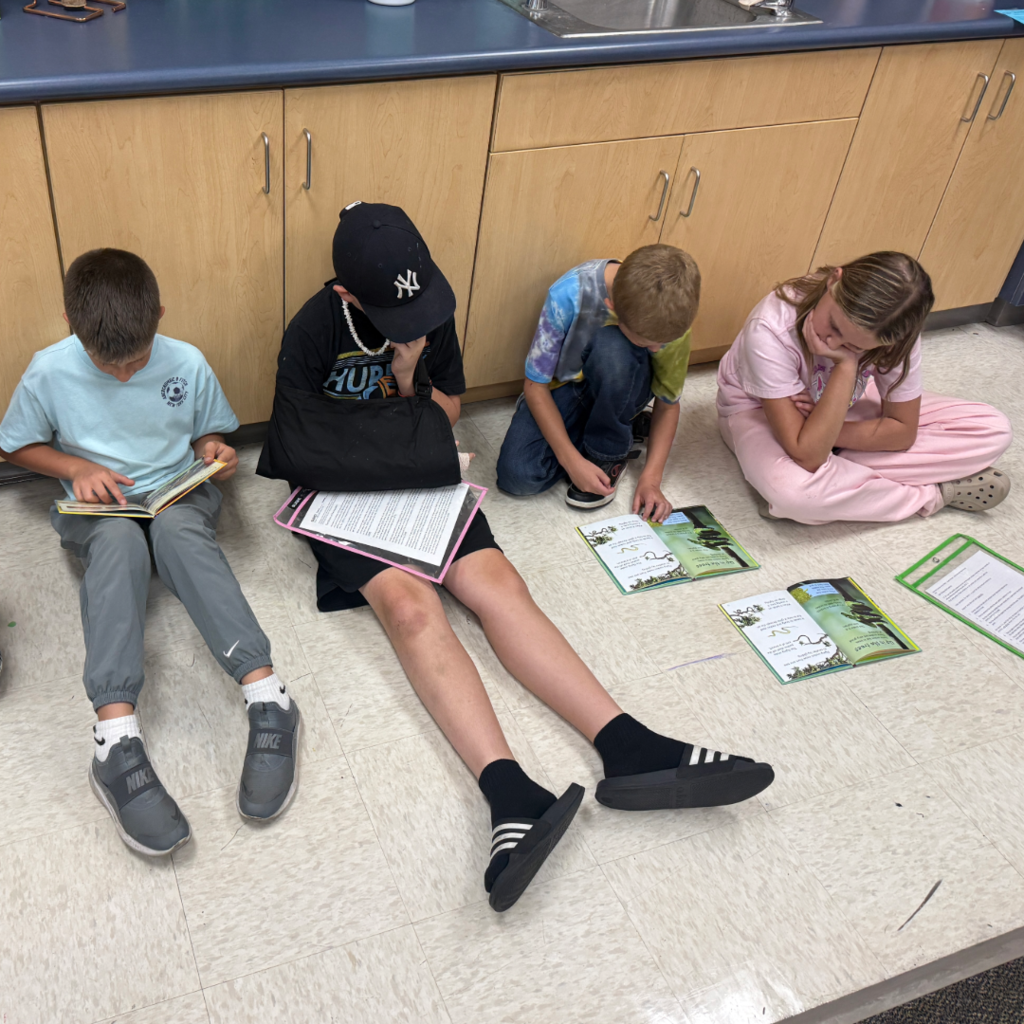 Students reading books with each other.