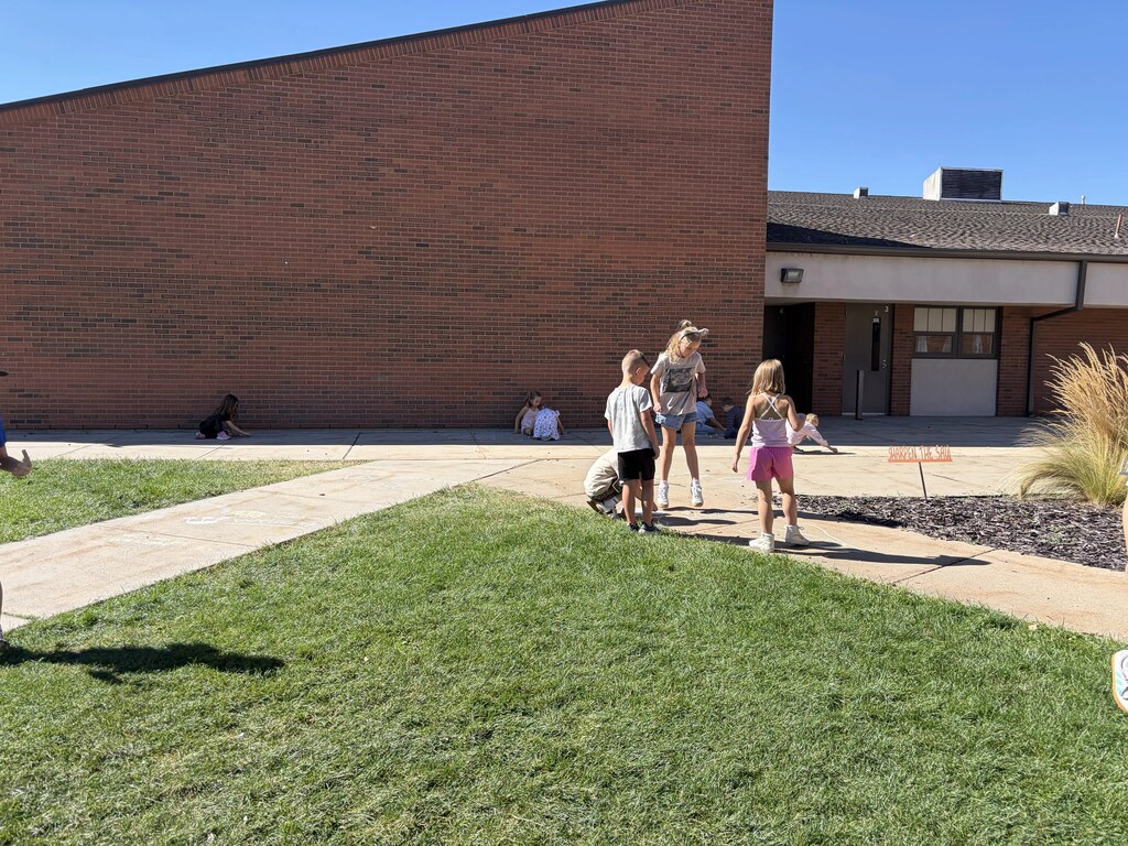 2nd graders chalking kind messages
