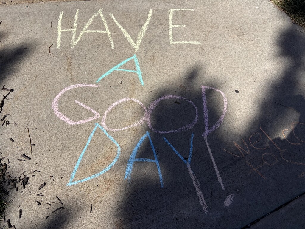 2nd graders chalking kind messages