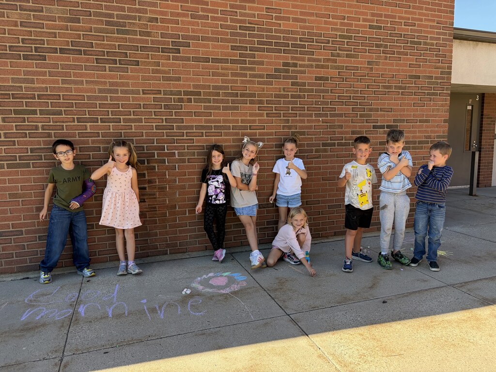 2nd graders chalking kind messages