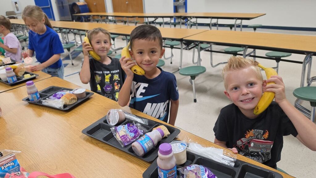 First graders on banana phones at lunch