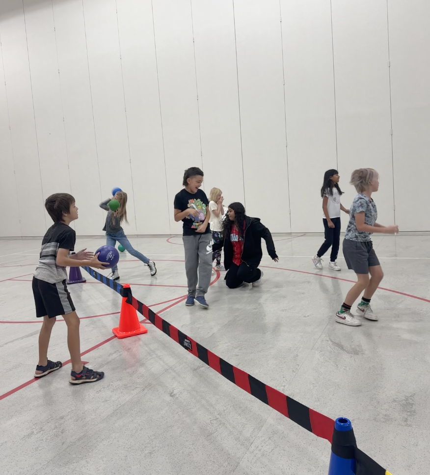 students playing a game with balls in PE