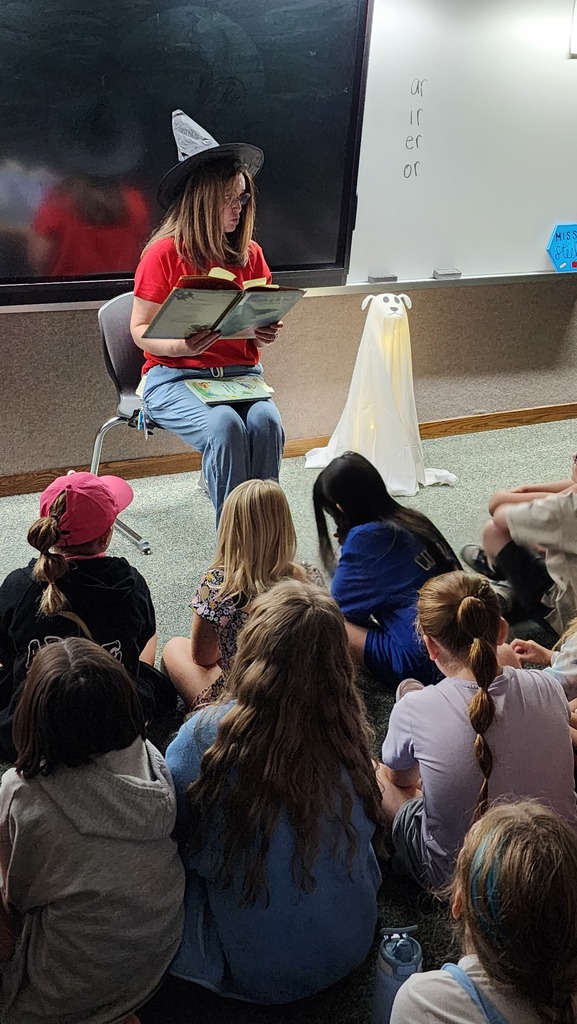 Teacher reading Halloween book to students