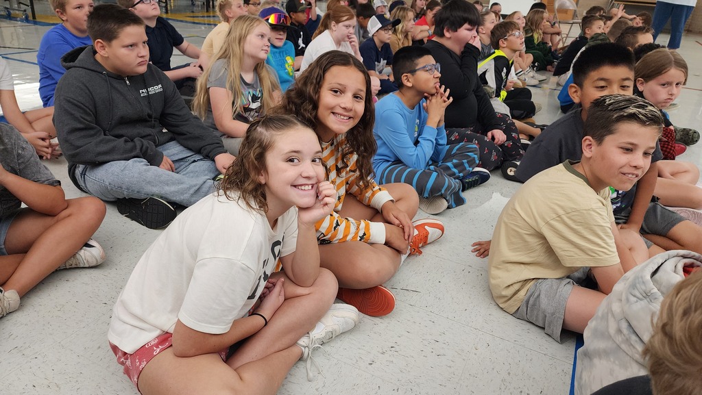 students listening to the story read by a teacher during the read-a-thon