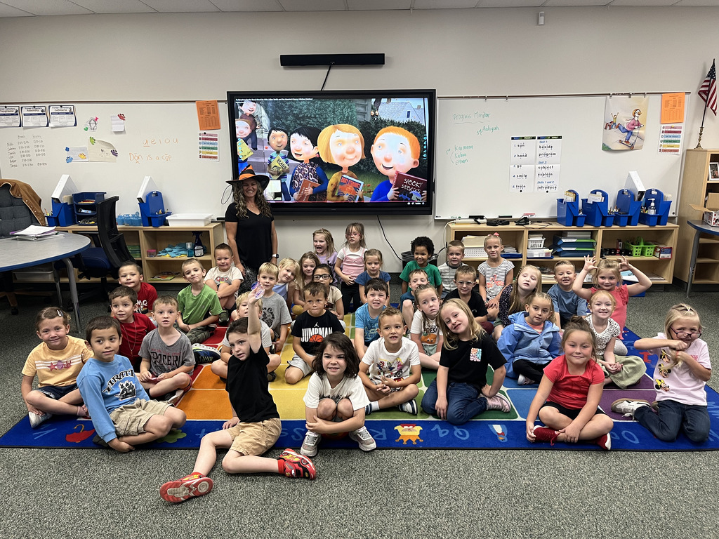 Teacher posing with students after reading a story