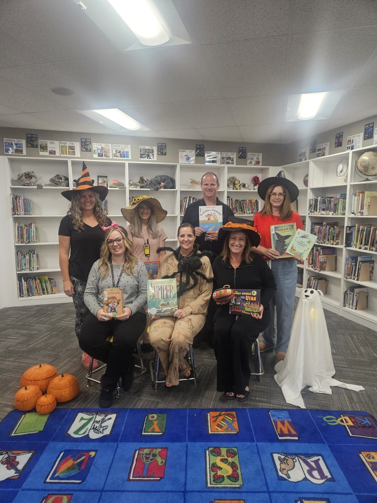 Staff smiling for the camera with the books they read to their kids