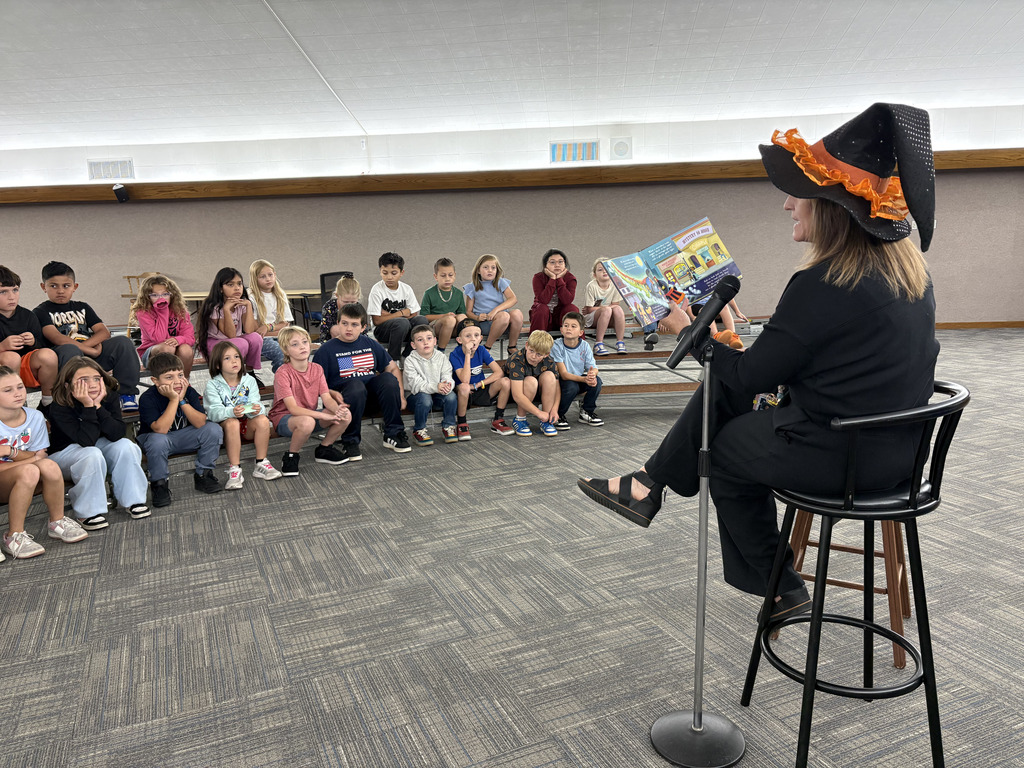 Principal reading student a story for the read-a-thon