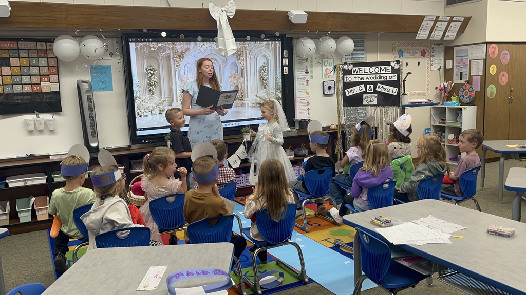 Teacher with students celebrating Q and U