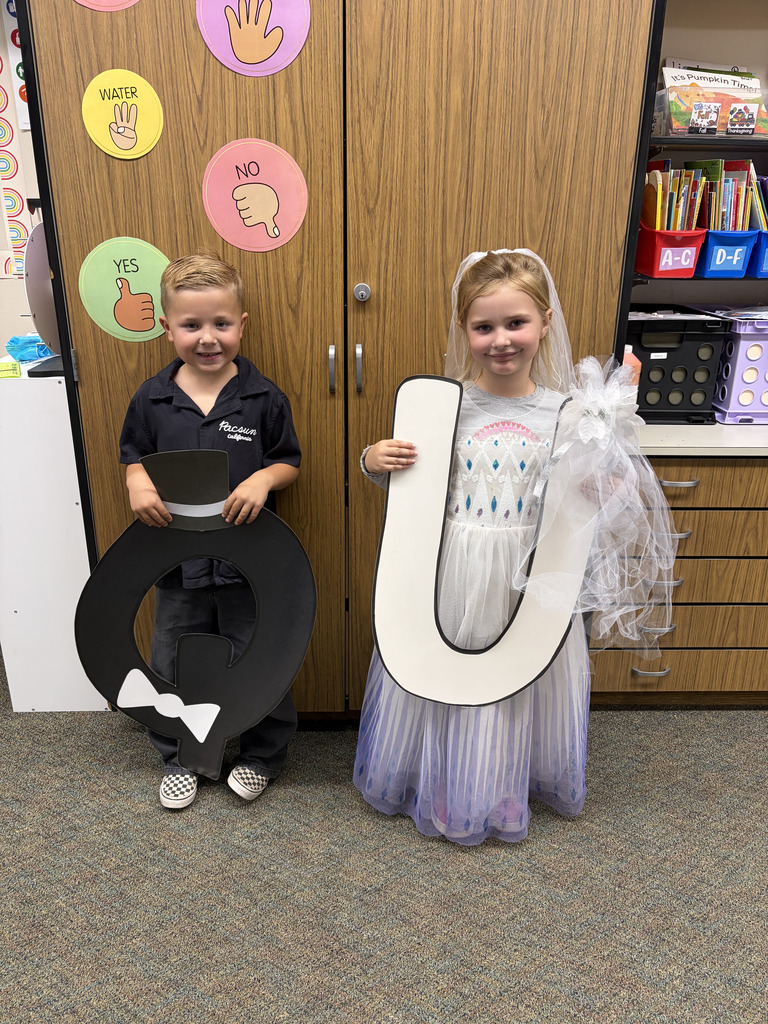 Students smiling for camera with Q and U