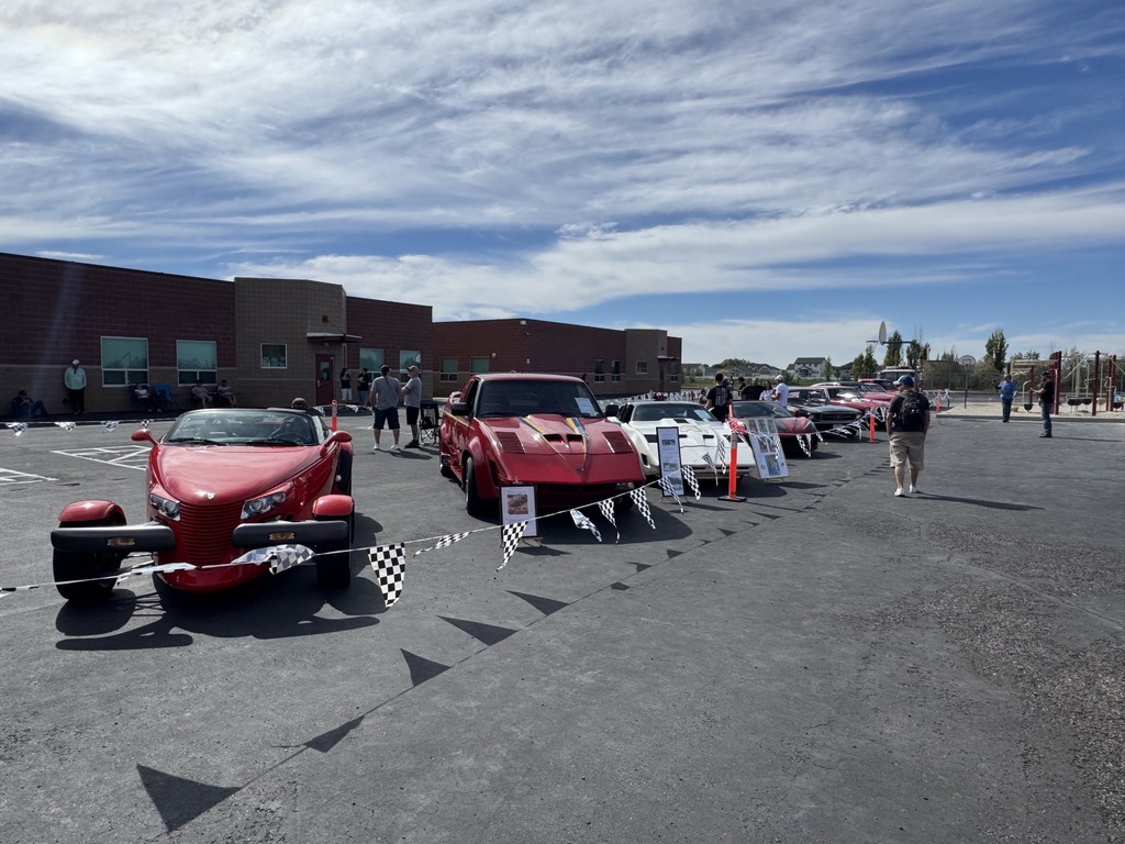 line up of old cars in the car show