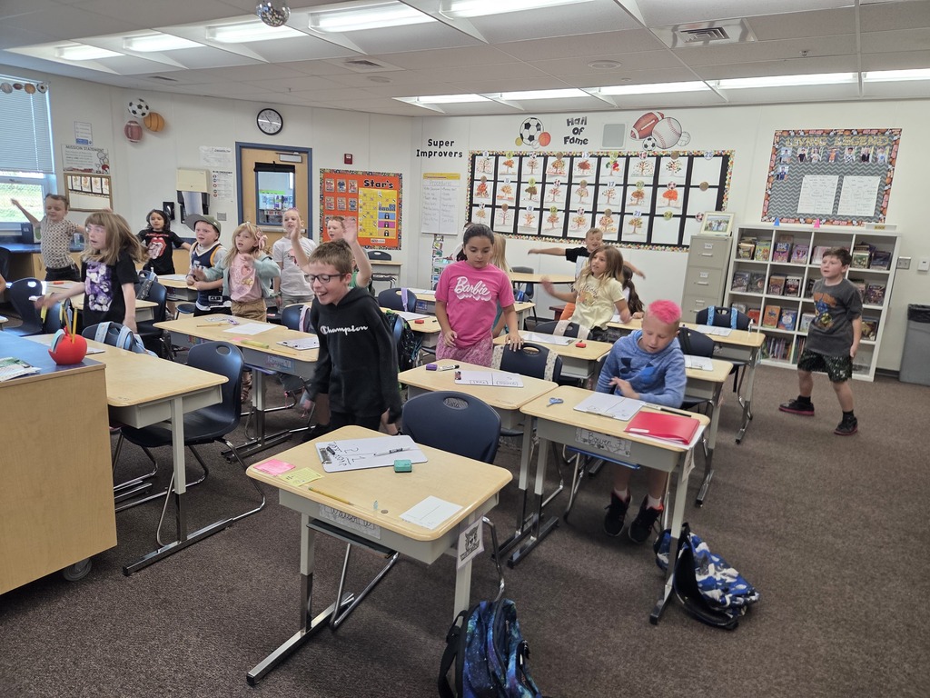 students moving their bodies and some are seen jumping and some are smiling and laughing