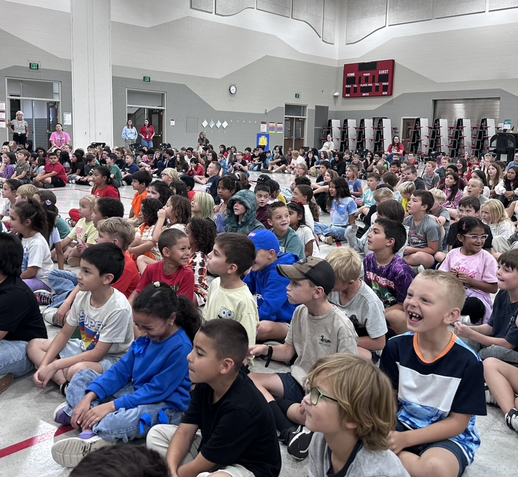 students sitting in an assembly excited about the PTA fundraiser