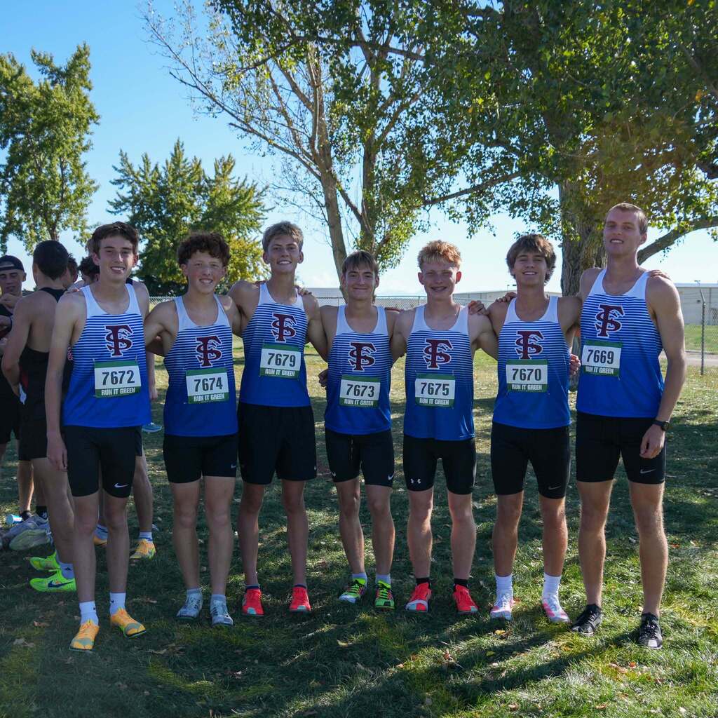 Image 2: Seven male student-athletes in matching blue and white striped cross-country uniforms standing side-by-side with arms around each other on the grass.