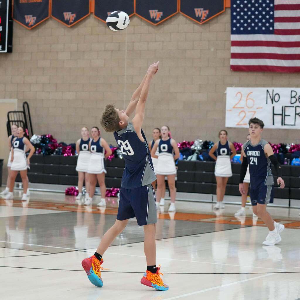 Image 5: An Orion Junior High volleyball player executing a precise jump-set during match play.