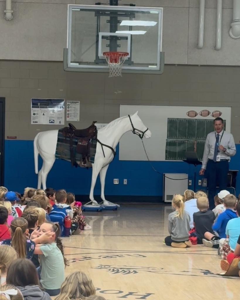 Photos from a school assembly at Hooper Elementary where students learned what it means to be a Mustang by showing grit, growth, and kindness. Additional photos feature a large Mustang mascot display that will be showcased at the front of the school.
