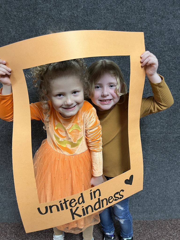 Great shot of smiling students posing behind the "Unity Day" frame.