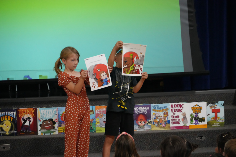 Students enjoying the Book drop assembly with Thal Dixon and Jennifer A. Nielsen.