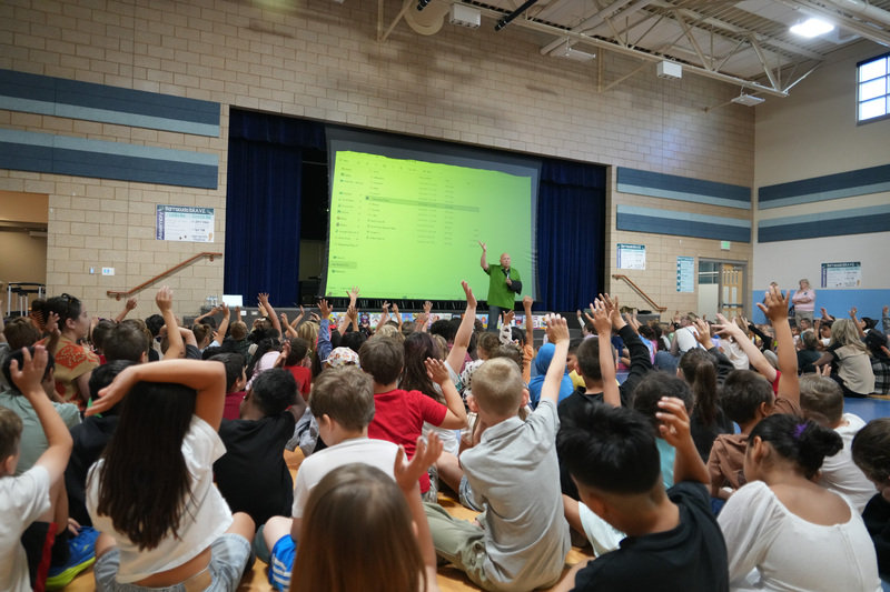 Students enjoying the Book drop assembly with Thal Dixon and Jennifer A. Nielsen.