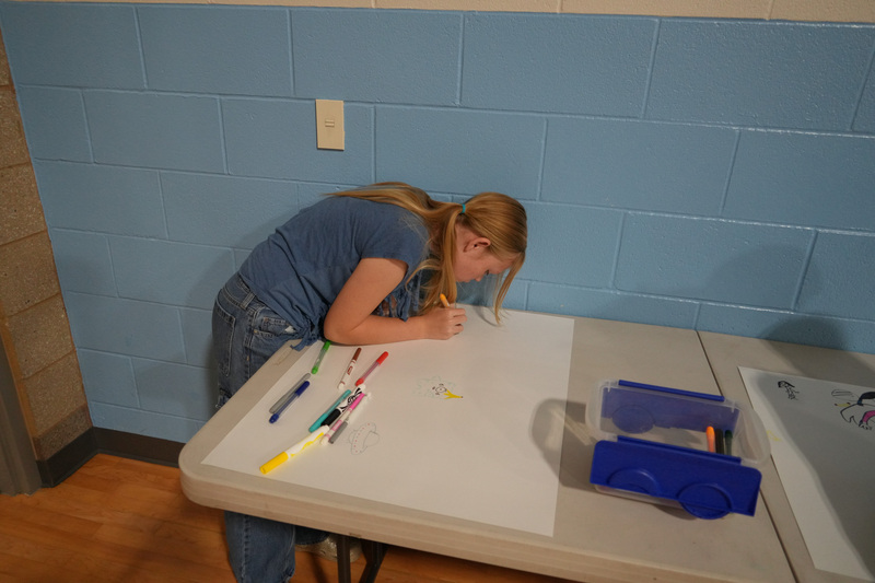 Students enjoying the Book drop assembly with Thal Dixon and Jennifer A. Nielsen.