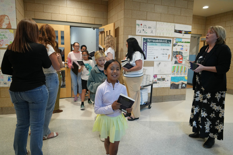 Students enjoying the Book drop assembly with Thal Dixon and Jennifer A. Nielsen.