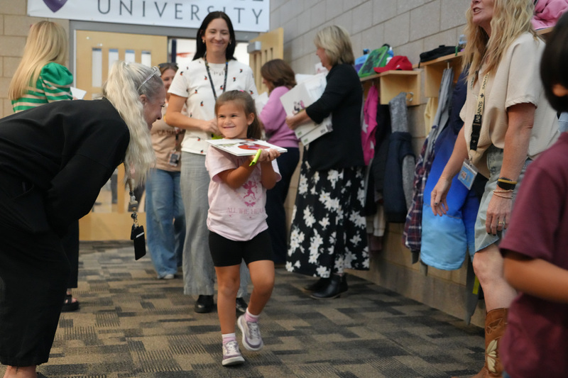 Students enjoying the Book drop assembly with Thal Dixon and Jennifer A. Nielsen.