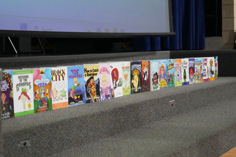 Students enjoying the Book drop assembly with Thal Dixon and Jennifer A. Nielsen.