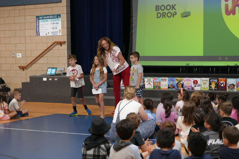 Students enjoying the Book drop assembly with Thal Dixon and Jennifer A. Nielsen.