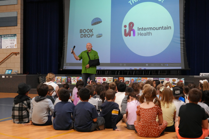 Students enjoying the Book drop assembly with Thal Dixon and Jennifer A. Nielsen.