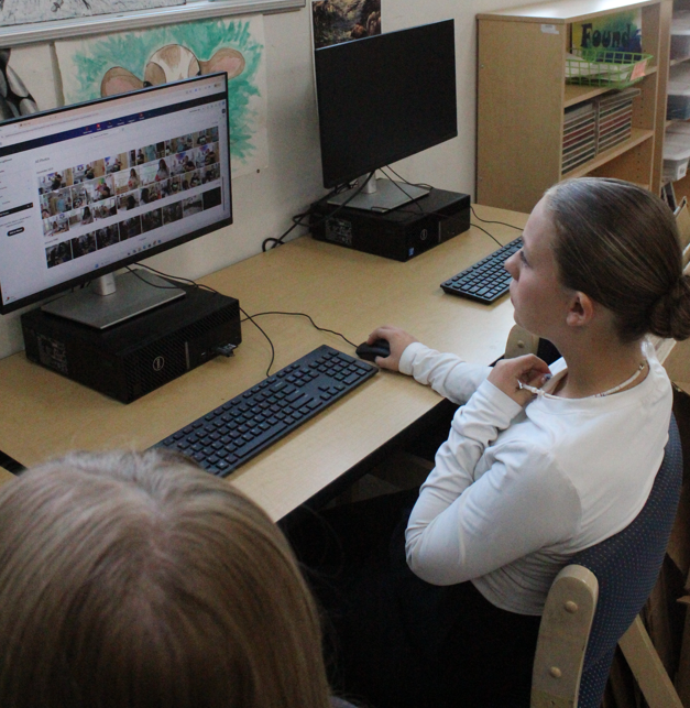 Student editing pictures for the school yearbook