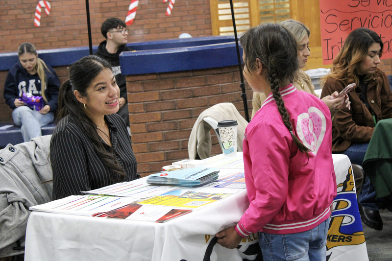 A student talks with a booth at the event. 