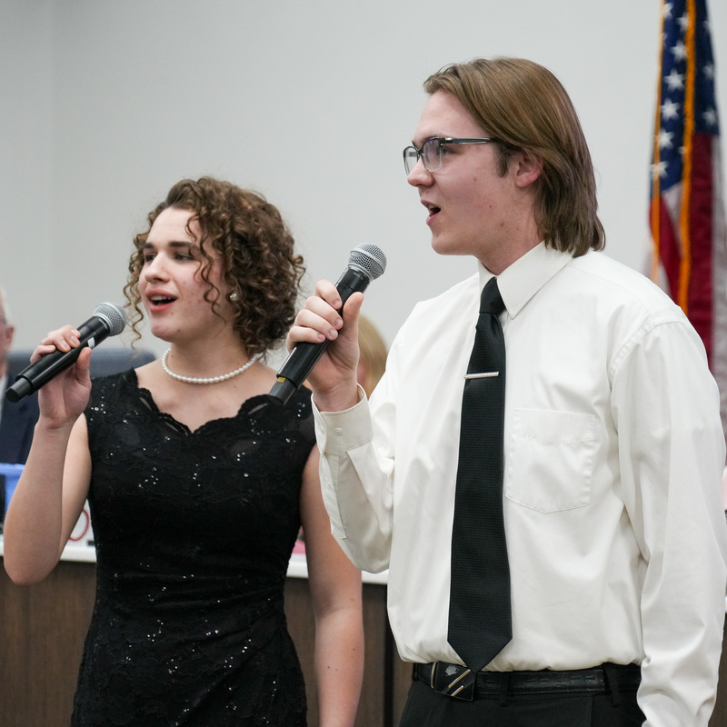 Students singing at board meeting