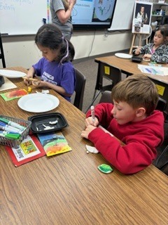 First graders making the life cycle of a butterfly