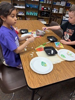 First graders making the life cycle of a butterfly