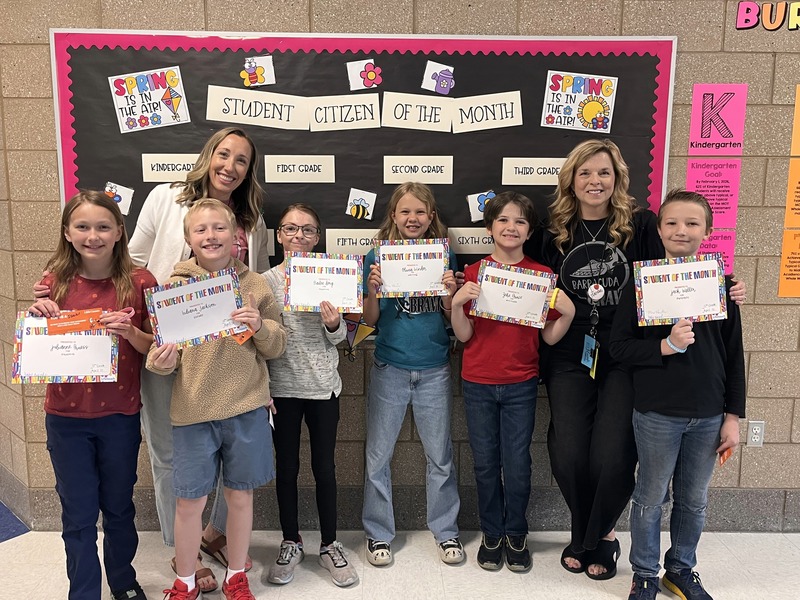 Teachers with their students that they awarded this month with student or citizen of the month. 