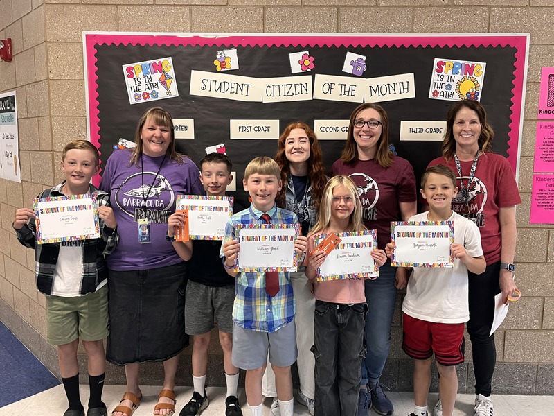 Teachers with their students that they awarded this month with student or citizen of the month. 