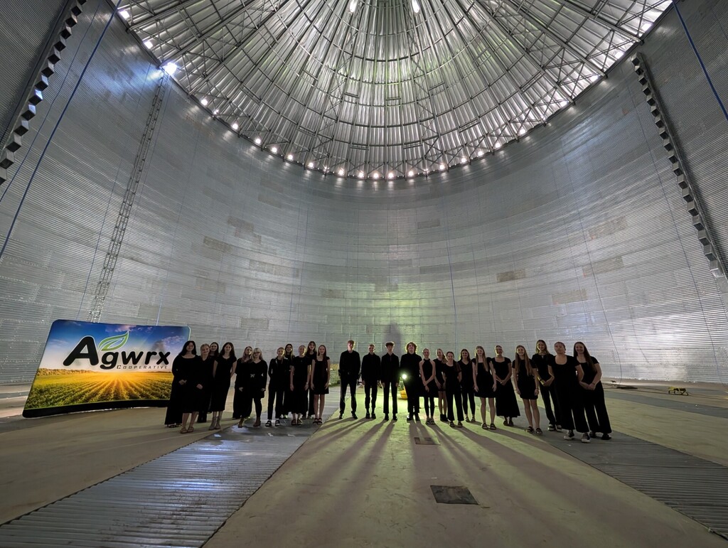 HS choir students standing inside new grain bin in Webster, SD prior to singing