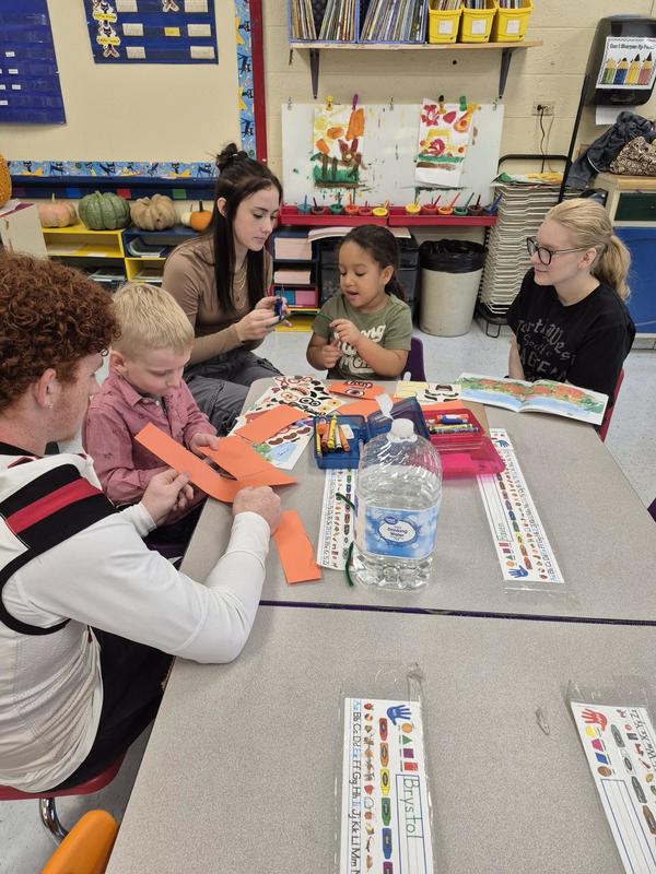 Children at a table cutting and doing a craft