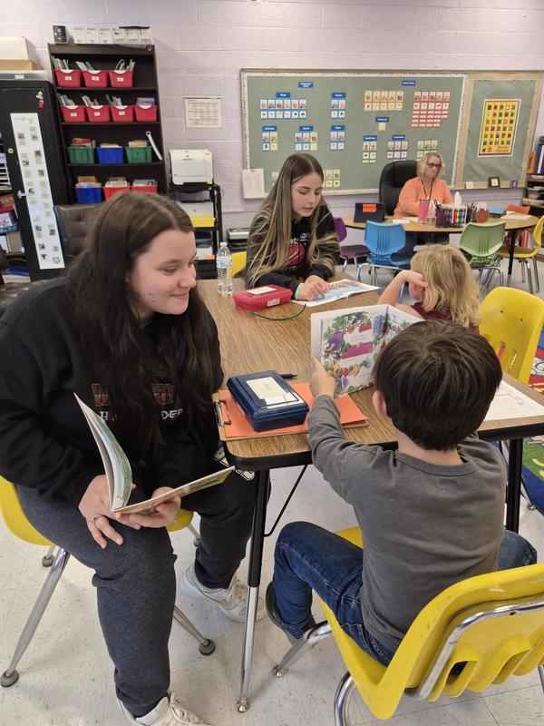 Children reading with a mentor