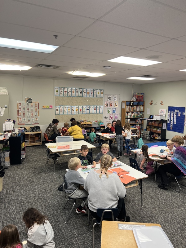 Children at tables working on a craft