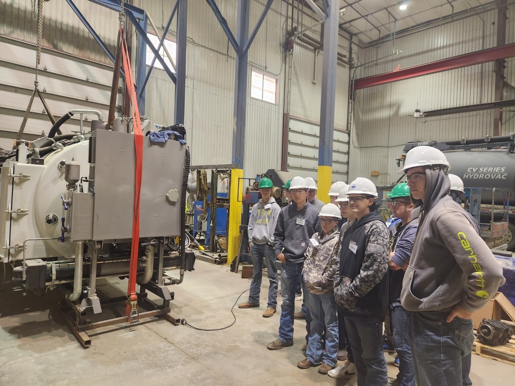 Students listening to the tour guide during a tour