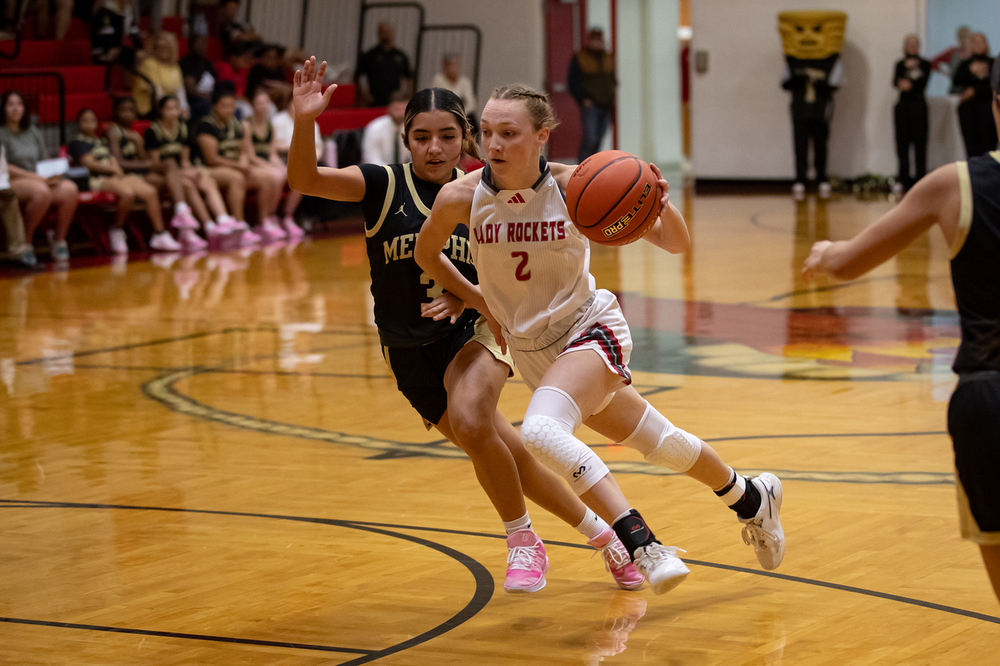 Taytum Kane drives to the basket against a Memphis defender